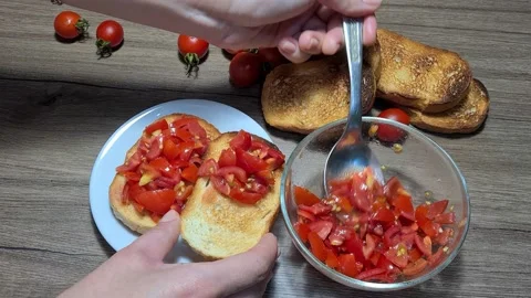 Making Bruschetta With Cherry Tomatoes And Garlic Stock Footage 160675191