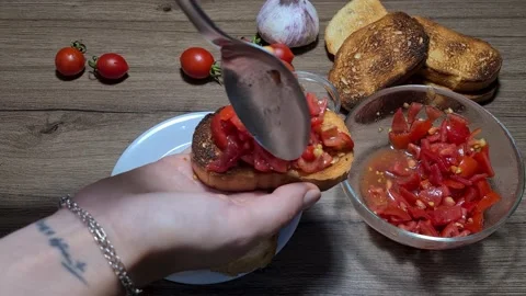 Making Bruschetta With Cherry Tomatoes And Garlic Stock Footage 160675261