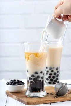 Making bubble tea, pouring blend milk tea into brown sugar pattern drinking g Stock Photos