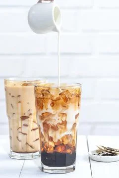 Making bubble tea, pouring blend milk tea into brown sugar pattern drinking g Stock Photos
