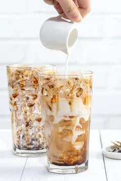 Making bubble tea, pouring blend milk tea into brown sugar pattern drinking g 스톡 사진
