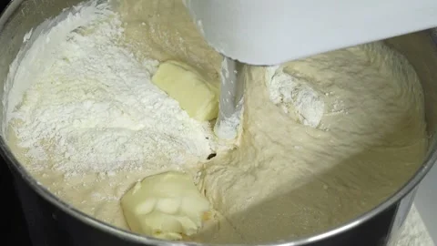 Making burger buns, adding butter to the dough into the mixer 库存影片 251324449