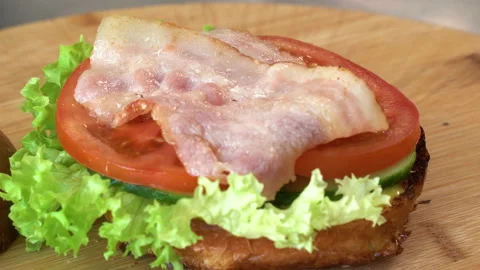 Making burger close-up, the hand of a chef in black gloves prepares a burger or Stock Footage 178533279