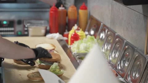 Making burger. cutlets and assembling hamburger in restaurant kitchen. Sound Stock Footage 145151871