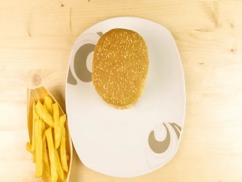 Making burger on wooden background - stop motion Stock Footage 75762906