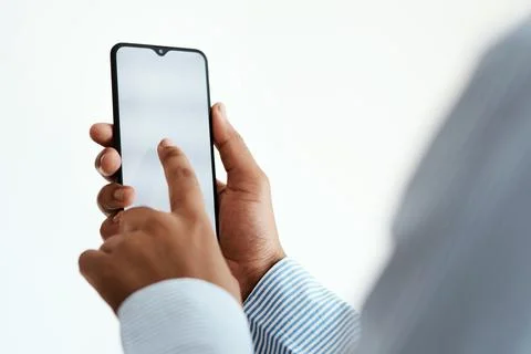 Making business moves in mobile format. Cropped studio sot of an unrecognisable Stock Photos