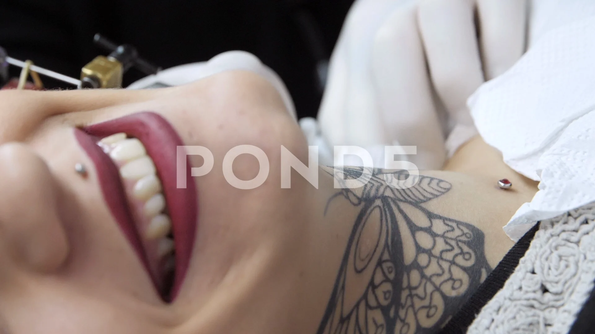 Making a butterfly tattoo on a woman's n... | Stock Video | Pond5