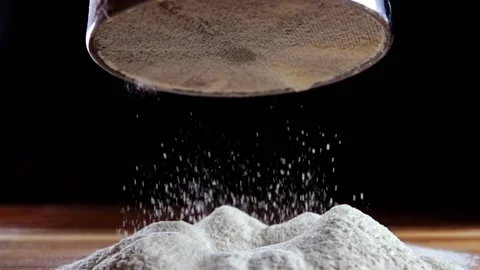 Making cake batter, sifting flour to make it more airy. Black and white Stock Footage