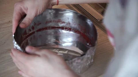 Making cake Red velvet at home. Pulling the foil on the mold.close-up Stock Footage 106438853