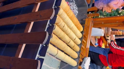 Making Cake Trdelnik or trdlo, sweet hollow roll pastry dough roasted over Video stock 296595891