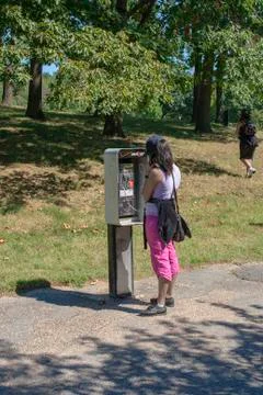 Making a call at a pay phone Foto stock
