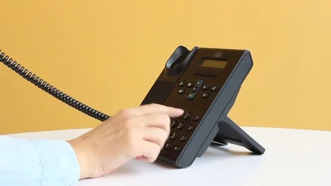 Making a call using desk phone Stock Footage 75941508
