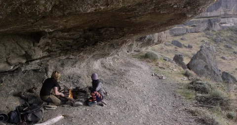 Making campfire in a cave Stock Footage 90404174