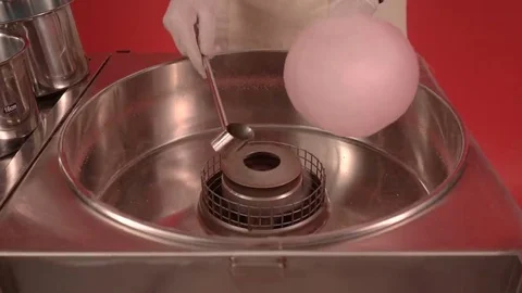 Making candy cotton with machine. Person creating pink sugar cotton Stock Footage 69176377