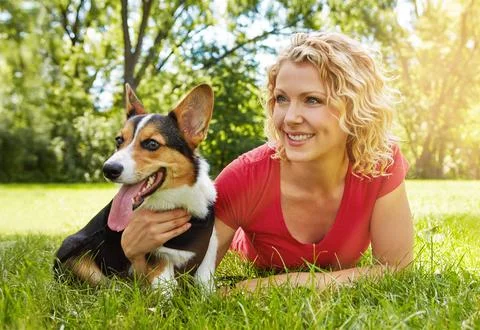 Making that canine connection. a young woman bonding with her dog in the park. Stock Photos