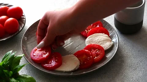 Making caprese salad with mozzarella, tomatoes and basil. Classic caprese salad. Stock Footage 160045112