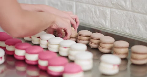 Making Caramel Macaroons. Close-up shot of connecting two halves of macaroons Video stock 150401869