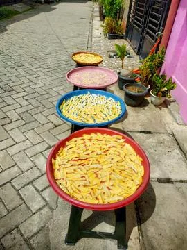 Making cassava chips which are dried before later being fried Stock Photos