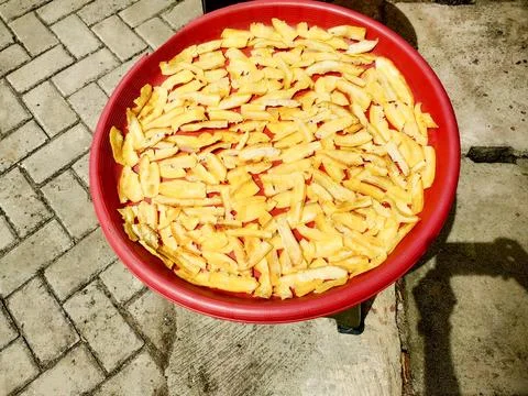 Making cassava chips which are dried before later being fried Stock Photos