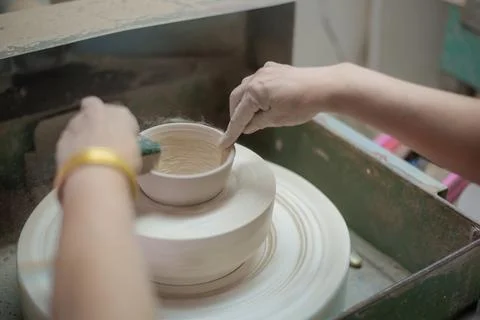 Making ceramic glasses.Making a round cup and polishing it into a round shape. Stock Photos
