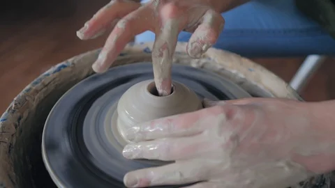 Making ceramic products from white clay. Women's  hands making clay cup Stock Footage 119542455