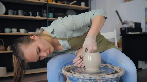 Making ceramic products from white clay. Women makes clay cup Stock Footage 119543033