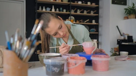 Making ceramic products from white clay. Girl in pottery studio 動画素材 119545690