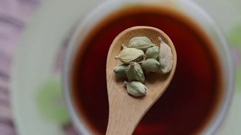 Making chai with cardamom in a warm kitchen Stock Footage 337143430