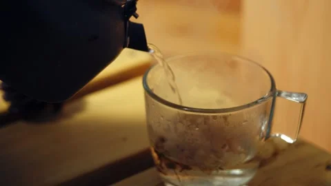 Making chammomile herbeal tea from kettle Stock Footage 321361938