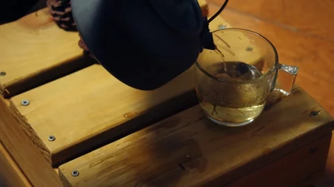 Making chamomile herbal tea from kettle Stock Footage 323123772