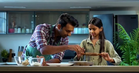 Making chapati together, father and daughter enjoying bonding in kitchen Stock-Footage 342845289