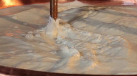 Making cheese, close up of mixed warm milk Stock Footage 68752140