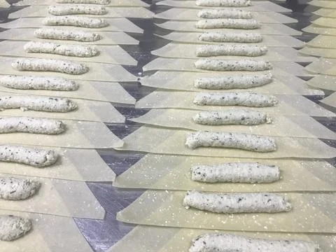 Making cheese roll on the table Stock Photos