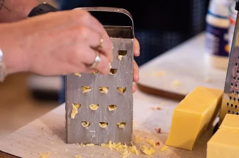 Making cheese rolls iconic new zealand dish cooking grating Stock Photos