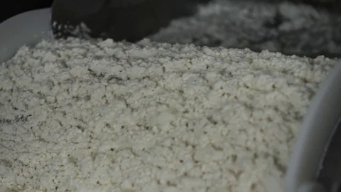 Making cheese Worker at the dairy makes cheese in containers of stainless steel Stock Footage 73834858