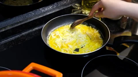 Making a Cheesy Omelette with Eggs, Melted Cheese, and Stirring with a Wooden Sp Stock Footage 274897471