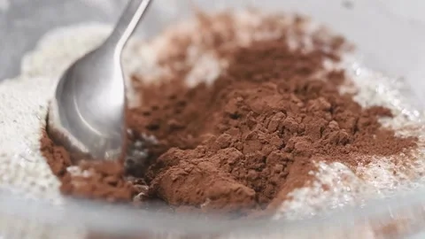Making chia pudding with cocoa. Stirring ingredients in a glass bowl. Stock Footage 153458909