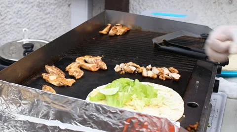 Making a chicken kabab pita wrap on a fast food restaurant counter Stock Footage 62076712