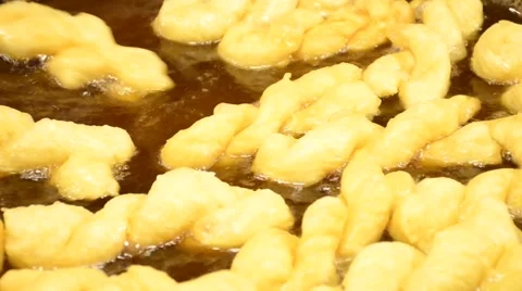 Making of Chinese dough stick  deep fried in  hot boiled oil on pan Stock Footage 61554196