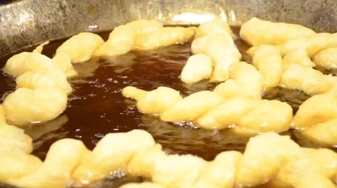 Making of Chinese dough stick  deep fried in  hot boiled oil on pan Video stock 61554207