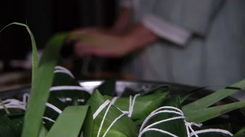 Making Chinese traditional rice dumpling (zongzi) for Dragon Boat Festival Stock Footage 130833451