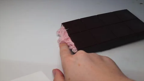 Making chocolate bars filled with Turkish pishmaniye. Chocolate bar with pink Stock Footage 303782534