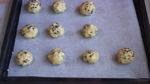 Making chocolate chips cookies, raw dough on the baking sheet Stock Footage 150673489