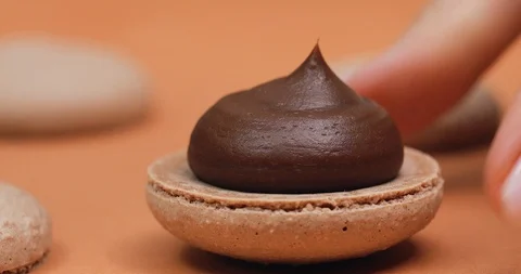 Making chocolate Macarons, add filling from the cooking bag, macro Stock Footage 101742542