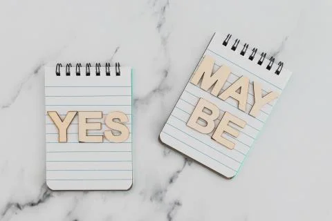 Making a choice and facing doubts, notepads with Yes and Maybe options Stock Photos