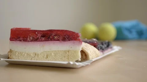 Making choice of sweets or sport, cakes and tennis balls Stock Footage 100193381