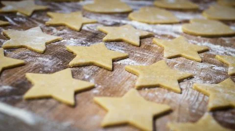 Making Christmas gingerbread biscuits. Cookie dough in heart and star shape. Stock Photos