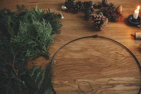 Making Christmas rustic wreath. Circle, cedar branches, pine cones, candle,.. Stock Photos