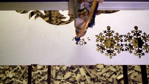 Making Christmas tree decorations (snowflakes) from wood on a laser machine Stock Footage 121229135