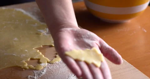 Making christmas tree shape cookies from a dough with a cookie cutter tool Stock Footage 151635365